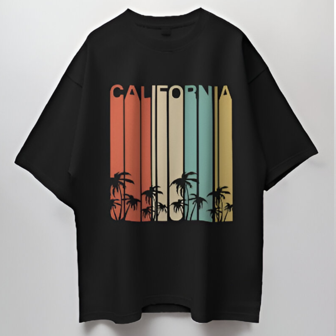 Individual lounging at a California beachside café, sporting the 'CALIFORNIA' oversized T-shirt, embodying West Coast vibes.