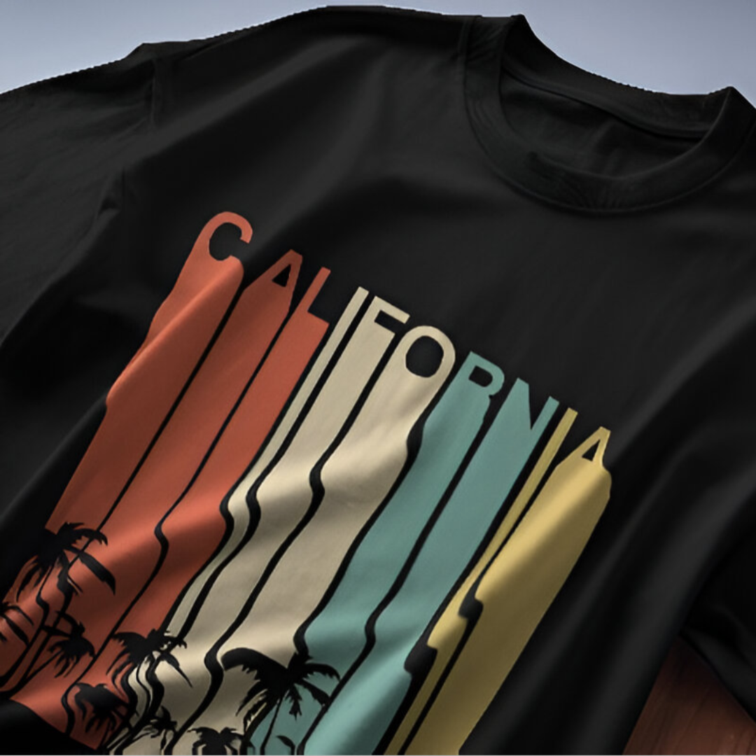 Detailed view of the vibrant 'CALIFORNIA' lettering and surfboard graphic on a premium quality yellow T-shirt.