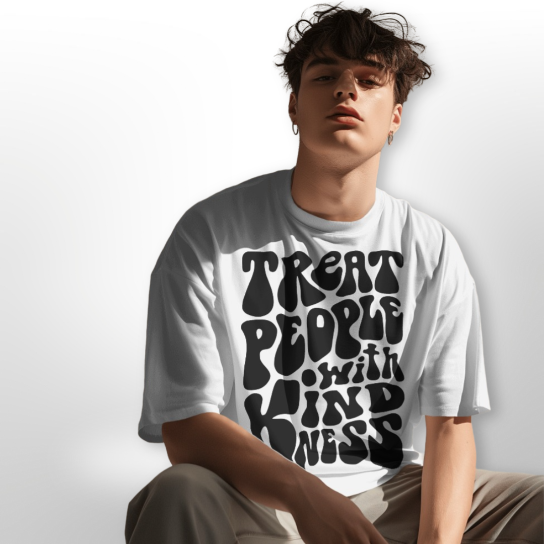 Model wearing the 'Treat People with Kindness' oversized T-shirt, paired with casual blue jeans for a relaxed look.