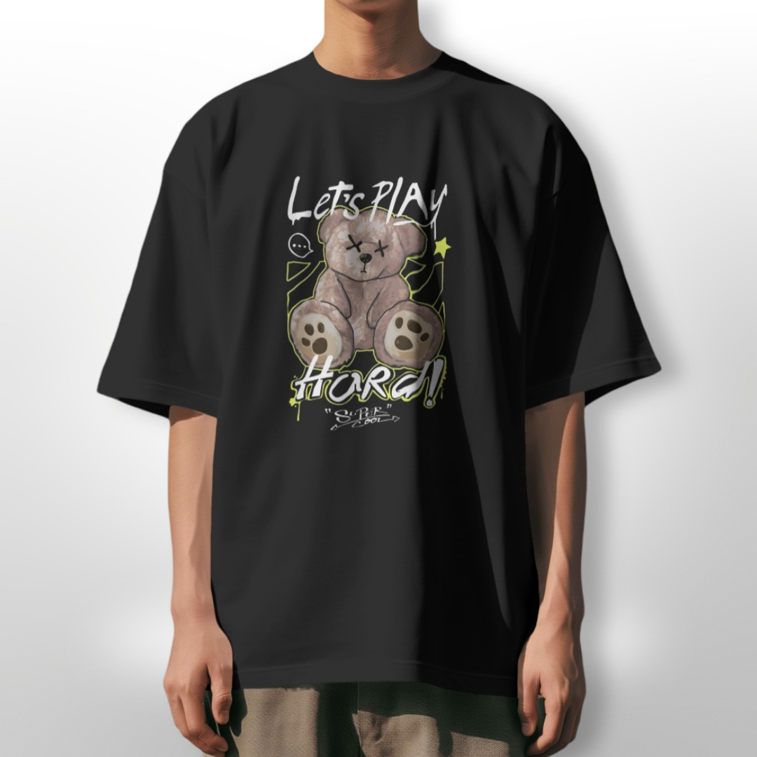 Model actively playing basketball wearing the 'Let's Play Hard' oversized T-shirt, showcasing its sporty appeal.