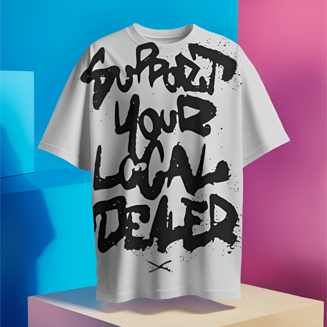 Streetwear scene with individual styling the 'Support Your Local Dealer' T-shirt at a bustling city market.