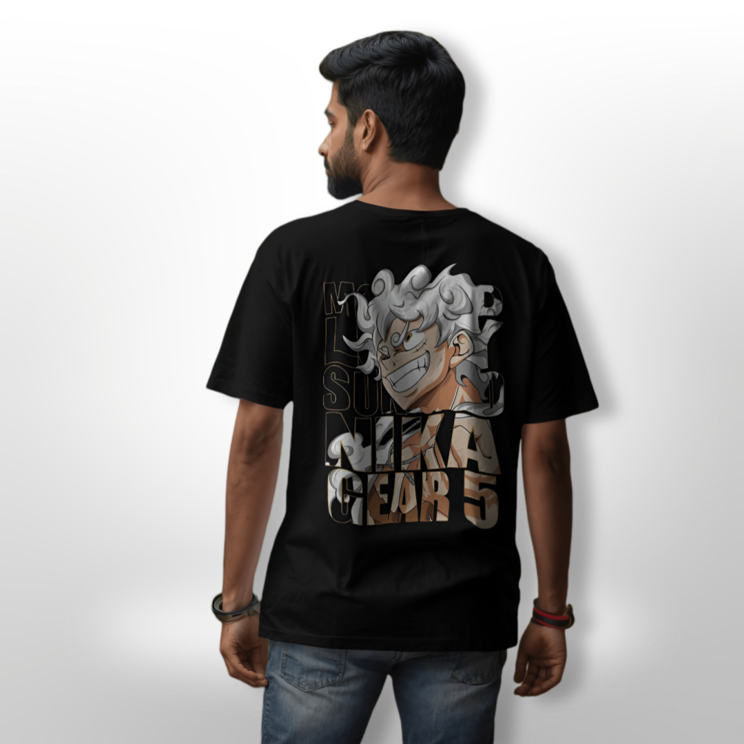 Model sporting the Monkey D. Luffy Sun God NIKA GEAR 5 oversized T-shirt at a casual outdoor anime event.