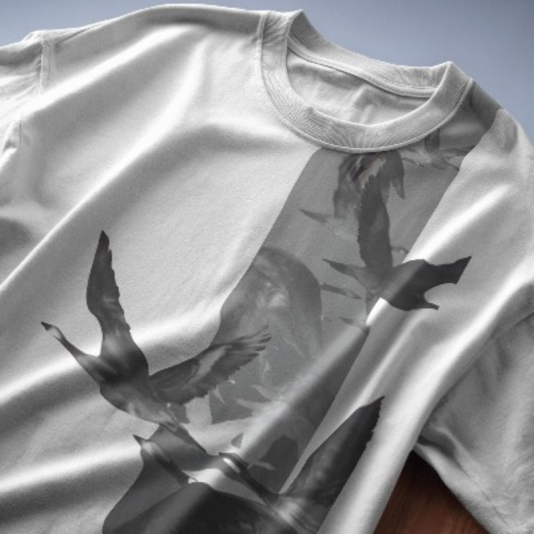 Close-up view of detailed Flying Flamingo illustration on oversized T-shirt fabric.